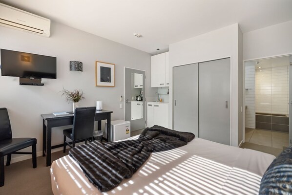 Single bedroom with kitchenette.... featuring a bar fridge and sink