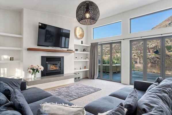 Gorgeous mountain views out of the large concertina doors to the huge outdoor patio and outdoor fireplace.

The oversized sofa and huge lounge room is perfect for families and friends to relax after hiking or skiing.  The perfect holiday home!
