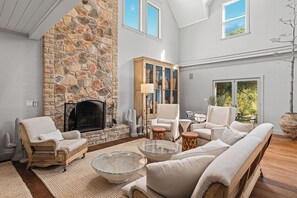 The living room is the heart of warmth and comfort, featuring a stunning stone fireplace that invites you to relax and unwind. With cozy seating and a welcoming atmosphere, it's the perfect spot to gather around the fire and enjoy quality time together.