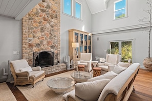 The living room is the heart of warmth and comfort, featuring a stunning stone fireplace that invites you to relax and unwind. With cozy seating and a welcoming atmosphere, it's the perfect spot to gather around the fire and enjoy quality time together.