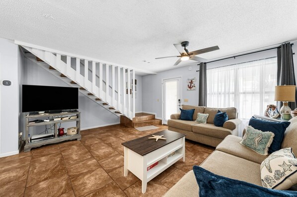 The living area is a spacious open-concept design, seamlessly connecting the kitchen, dining, and lounge spaces.