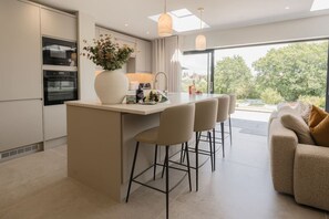 The Open Plan Living Space: pull up a chair at the kitchens island and enjoy a hot drink or a glass of something cold & fizzy!