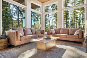 Comfortable living room with spectacular views of the surrounding forest.