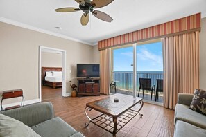 Open concept living area with stylish furnishings TV balcony access and sofa bed