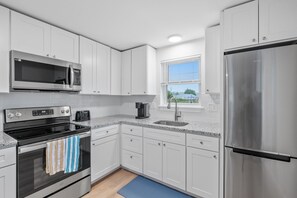 Kitchen equipped with modern appliances including countertop dishwasher.