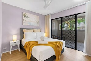 The primary bedroom offers a queen-sized bed and direct access to a seating nook on the patio.
