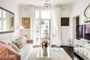 Bright and inviting, the living room’s vintage décor and cosy seating create an ideal spot to unwind.
