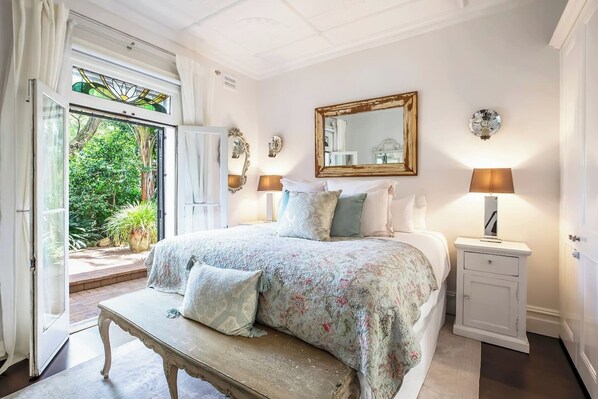 Rest in the parimary bedroom, complete with a king-sized bed and direct access to the shared bathroom.
