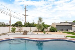 Dive into relaxation by the pool in this vibrant and colorful outdoor space, perfect for soaking up the sun and making memories.