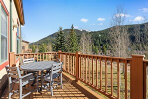 Private balcony with outdoor seating, gas grill and slope views.