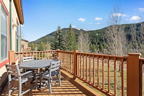 Private balcony with outdoor seating, gas grill and slope views.