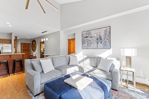 Living area with mounted flat screen TV, gas fireplace and access to the private balcony.