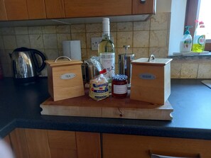 Tea, coffee, Welsh cakes, Jam and wine on a wooden board