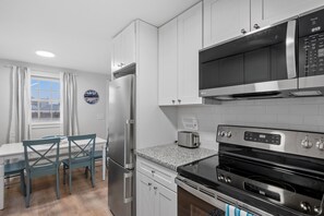 Kitchen equipped with modern appliances including dishwasher.