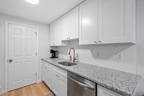 Kitchen is stocked with utensils and cookware to prepare your favorite meals.