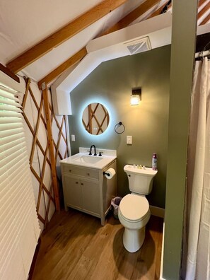 Step outside to your private outdoor oasis featuring a cozy deck, grill, and shaded seating area. Relax by the fire pit with free firewood provided. This peaceful retreat offers the perfect blend of comfort and adventure.