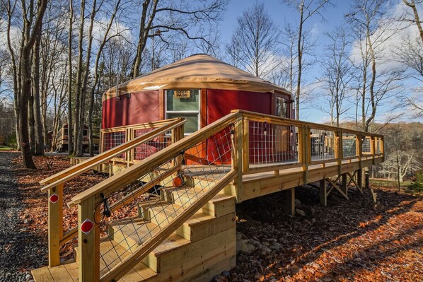 Step outside to your private outdoor oasis featuring a cozy deck, grill, and shaded seating area. Relax by the fire pit with free firewood provided. This peaceful retreat offers the perfect blend of comfort and adventure.