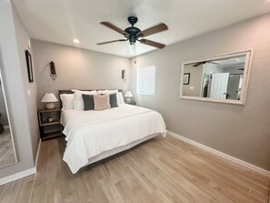 Primary bedroom with king bed, smart TV, and large closet