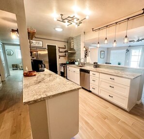 Spacious, open, well-equipped kitchen with stainless steel appliances