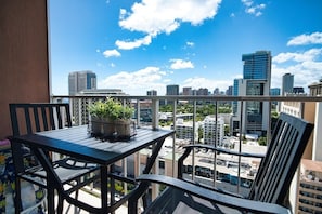 Bar height seating area on lanai (balcony). Enjoy the city, ocean and mountain views.