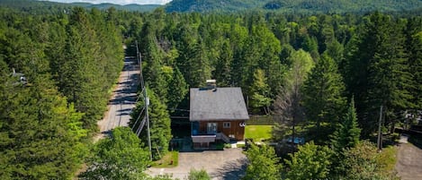 Aerial view of the property nestled among trees—peaceful and surrounded by nature.