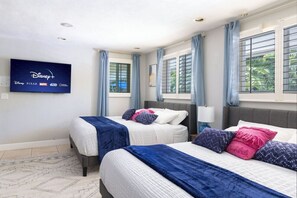 blue and pink style bedroom with 2 kings and bunk bed