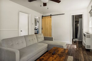 Relax in the modern living area featuring a comfortable sofa, flat-screen TV
