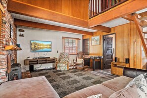 Cozy and spacious living area with air hockey game