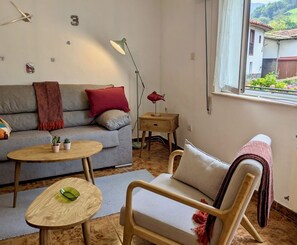 spacious living room with huge windows and lots of light