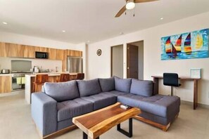 Unwind with loved ones in a cozy living room with TV & workspace.