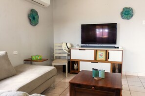 Relax in the cozy living room, complete with a comfortable sofa and a flat-screen TV
