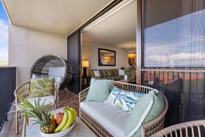 Enjoy this living space with tropical decor, direct lanai access, and views of the ocean, creating a seamless indoor-outdoor retreat.