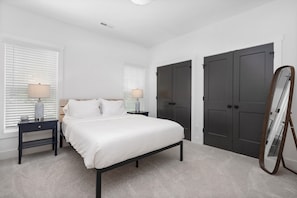 2nd bedroom boasts luxurious queen sized bed and bedside lamps with charging.