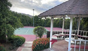 Gazebo overlooks tennis court. 