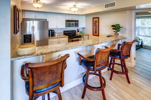 The updated kitchen features sleek stainless steel appliances & elegant granite countertops, combining style & functionality.
