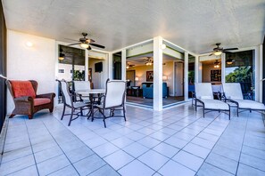 Savor a meal while enjoying the tropical breezes on the screened porch, offering a peaceful and refreshing dining experience.