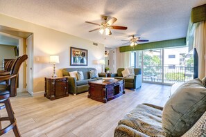 The living room features comfy seating and a pull-out full-sized sofa bed, providing extra comfort and flexibility for guests.