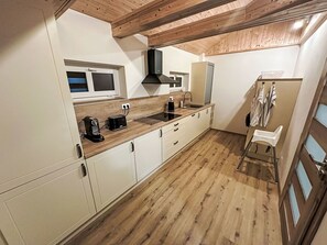 Cabinetry, Wood, Countertop, Flooring, Floor, Building, Window, Wood Stain, Hardwood, Kitchen