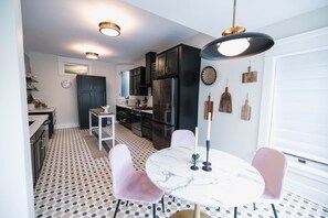 Gather around the elegant dining table, perfect for enjoying meals together. This charming space is ideal for family dinners or a quiet meal with loved ones, combining historical style with modern comfort.