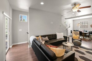 Relax on the plush L-shaped sofa while enjoying your favorite shows on the wall-mounted flat-screen Smart TV with soundbar.
