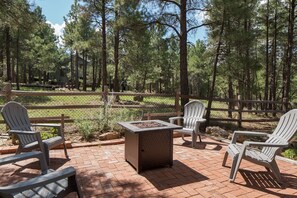 Backyard features a fire pit, dining area, and ample space for games or quiet moments.