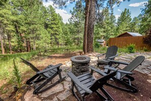 Cozy outdoor seating area with a firepit, perfect for warm gatherings and starry nights.