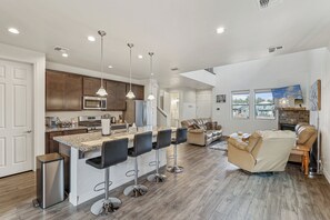 Fully Stocked Kitchen: Cook up a meal hassle-free with stainless steel appliances, granite countertops, and all the kitchen essentials you need.