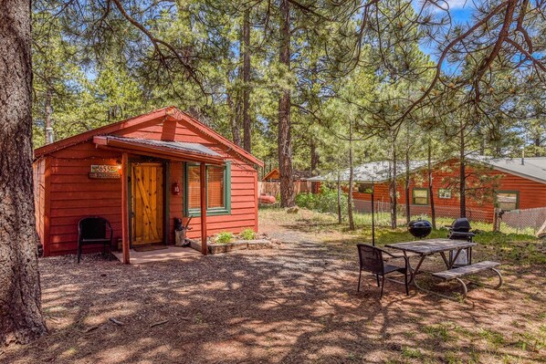 Welcome to The Bunk House by PORTER. Experience a retreat like no other at this historic shotgun cabin nestled in the cool pines of Northern Arizona.