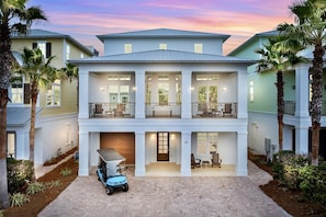 Sunset Manor—your perfect group getaway that SLEEPS 26! Just steps from PRIVATE beach access, this stunning retreat includes a FREE golf cart. Unwind in the backyard oasis with a heated pool, hot tub, outdoor kitchen, and lounge seating. Plus a game room!