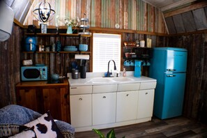 Kitchen With Electric Cooktop and Full Fridge