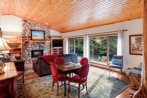 Upscale living room, large enough for a big group!  The river flows along this wall of windows!