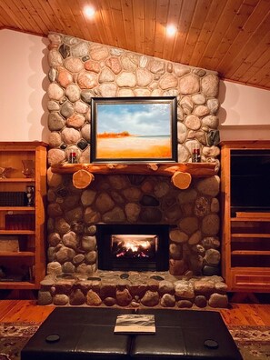 Cozy gas fireplace after a day on the slopes with a beautiful view through the windows of the river and snow outside!