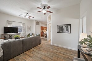 Open concept entryway leading to a living room with cozy couches.
