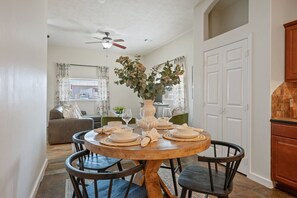 Rustic round dining table with seating for four.
